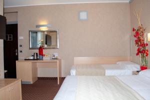 Postel nebo postele na pokoji v ubytování Hotel Susa