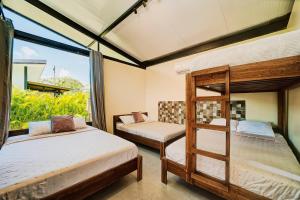 Dos literas en una habitación con ventana. en Casa Gaviota 1 - Pool, comfort & great location, en Puerto Viejo