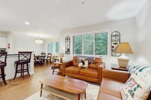 a living room with a couch and a table at Vantage Point #7 in Stratton