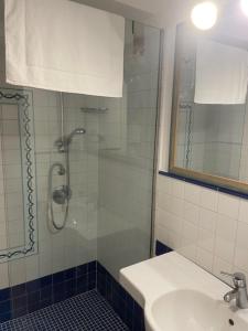 a bathroom with a shower and a sink and a sink at Agenzia Isotur Villa Olimpia in Ponza