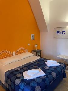 a bedroom with a bed with two towels on it at Agenzia Isotur Villa Olimpia in Ponza