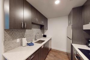 Una cocina con gabinetes de madera y un fregadero. en Pioche Village #1235, en Park City