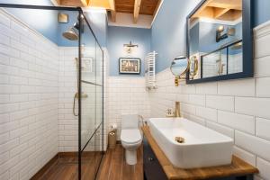 a bathroom with a sink and a glass shower at Old House Apartments 2 Poznań in Poznań +44 photos