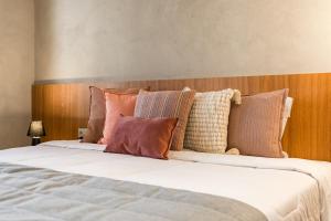 a bed with many pillows on top of it at TW Cyclinn Vila Olimpia in São Paulo