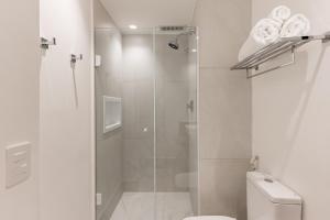 a bathroom with a glass shower with a toilet at TW Cyclinn Vila Olimpia in São Paulo