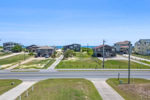 an empty street in a residential neighborhood with houses at Carolinian in Nags Head