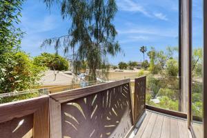 a balcony with a view of a yard at Sea & Stroll Abode - Beautiful dog friendly home in Carlsbad Village w/private grill, backyard, W/D in Carlsbad