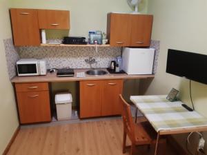 a small kitchen with a table and a microwave at Apartmány Kroměřížsko in Hulín