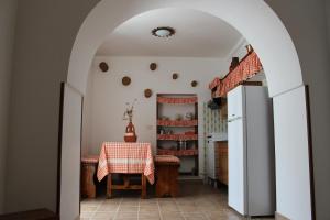 an archway in a kitchen with a table and a refrigerator at Il Sogno Apartments in Alberobello