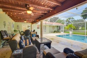 a patio with furniture and a swimming pool at 16 Mi to Fort Lauderdale Florida Escape with Pool! in Plantation
