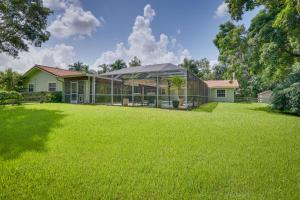 a large green yard with a glass house at 16 Mi to Fort Lauderdale Florida Escape with Pool! in Plantation