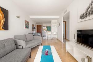 a living room with a couch and a table at Apartment Holiday Haven in Punta Prima