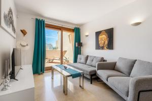 a living room with a couch and a table at Apartment Holiday Haven in Punta Prima