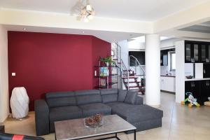 a living room with a couch and a table at Coastal Horizon in Myloi