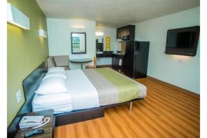 a hotel room with a large bed and a kitchen at Motel 6-Palestine, TX in Palestine