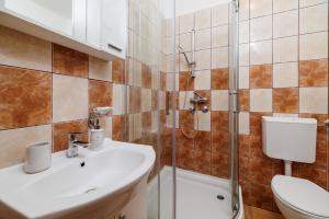 ein Badezimmer mit Waschbecken, Toilette und Dusche in der Unterkunft Apartments Toni in Banjol + 54 Fotos