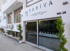 a building with a sign that reads kaminova hotel at Kariva Hotel in Antalya