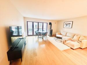 a living room with a couch and a table at Tjuvholmen apartment 2BR in Oslo