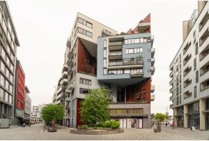 a tall building in the middle of a city at Tjuvholmen apartment 2BR in Oslo