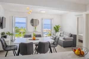 a living room with a white table and chairs at Apartments Amfora 2 in Podgora