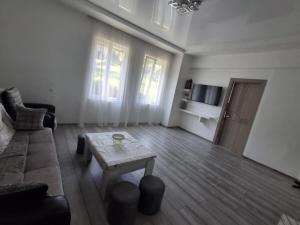 a living room with a couch and a coffee table at Nutsa House in Ts'ikhisdziri