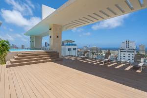 a rooftop deck with a view of a city at JR 7 Suites by Yellowkey in Santo Domingo