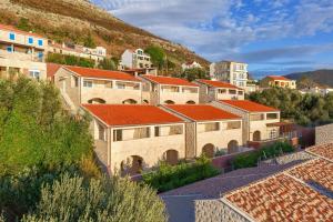 a group of buildings with red roofs on a hill at NAVU Apartment in Katun