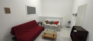 a living room with a red couch and a table at Estación 824 in Tandil