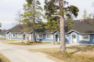 a blue house with a tree in front of it at Apartment Saariselkä in Saariselka