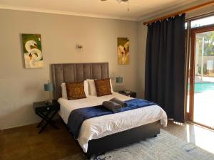 Ένα ή περισσότερα κρεβάτια σε δωμάτιο στο Waterkloof Glen Guest House +56 φωτογραφίες