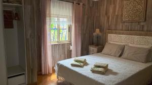 a bedroom with a bed with two pillows on it at Imperio de Memorias - Casa de Campo in Vale Bordalo +35 photos