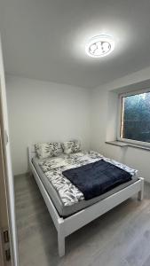 a bedroom with a bed in a white room at Apartament Nad Potokiem in Mieroszów +17 photos