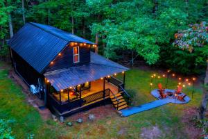 a tiny house with a porch and a deck at Meadow Retreat - Hot Tub, Fire Pit & Games in Morganton +43 photos