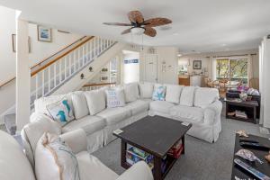 a living room with a white couch and a table at Corolla & Lime in Corolla