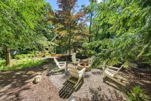 a group of chairs sitting in a yard with trees at Oasis in the Woods in New Buffalo