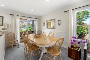 a dining room with a wooden table and chairs at Corolla & Lime in Corolla