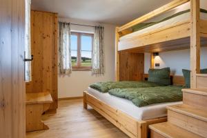 a bedroom with a bunk bed and a staircase at Stadlerhof Alpen- & Seeblick in Kirchanschöring