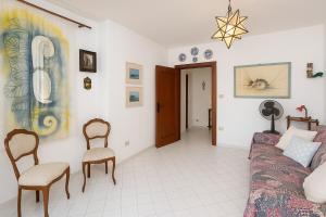 a living room with a couch and two chairs at Dream View in Positano in Positano