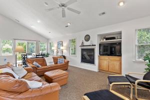 a living room with two couches and a fireplace at Country Roads in Corolla