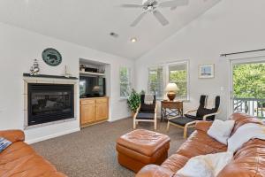 a living room with a couch and a fireplace at Country Roads in Corolla