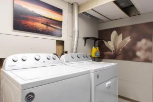 a kitchen with a white stove and a painting at Relaxation Station - Hot tub and scenic location downtown South Haven in South Haven +30 photos