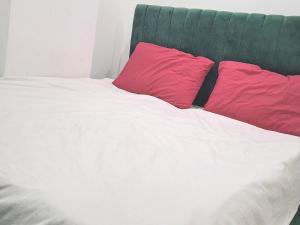two red pillows sitting on top of a bed at Marina Bay Elegance Room Balcony Overlooking Luxury Yachts in Hurghada