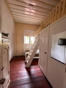 a small room with a staircase and a tv at La Posada de La Abuela Salento in Salento