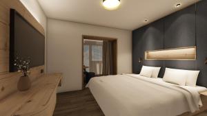 Rúm í herbergi á Hotel Zauchenseehof