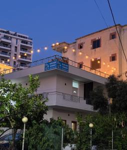 a building with a balcony with lights on it at Hotel Barjami in Sarandë