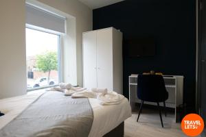 a bedroom with a bed and a desk and a window at Private Double Rooms By Travel Lets Short Term Rental Agency Derry in Derry Londonderry