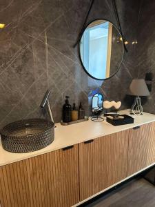 a bathroom with a sink and a mirror on a counter at Eleny Apartments in Perea