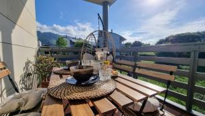 a wooden table with plates of food on a balcony at Apartamento Las Xanas in Llanes