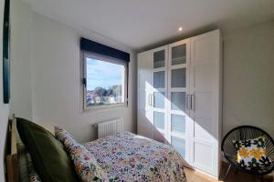 a bedroom with a bed and a window at Apartamento Las Xanas in Llanes