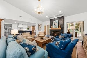 a living room with blue couches and a fireplace at 2565 The Haul Over in Seabrook Island